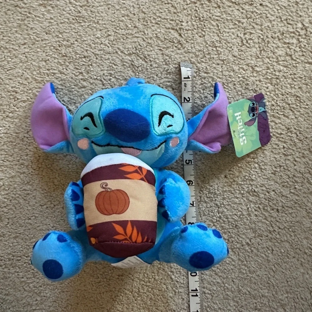 Stitch holding a coffee